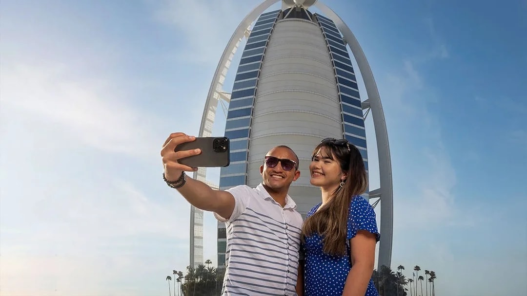 Tourists taking a selfie in front of Burj Al Arab during Inside Burj Al Arab Tour in Dubai.