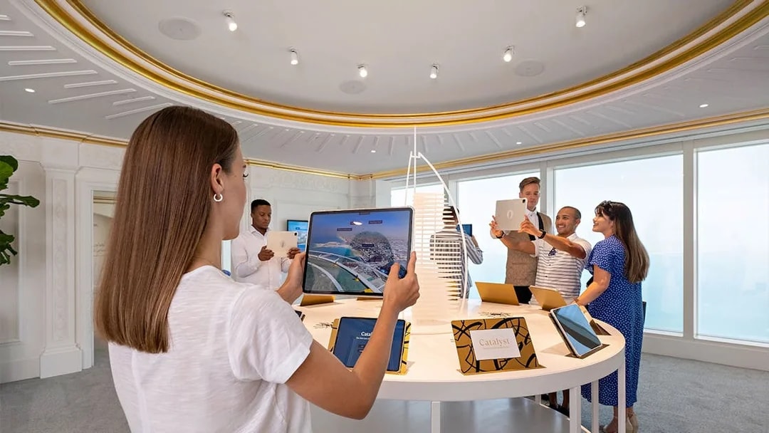 Guests exploring digital displays during Inside Burj Al Arab Tour at UMA Lounge.