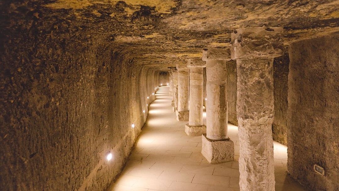 Ancient stone columns and brick walls inside the Step Pyramid of Djoser, Saqqara, Egypt.