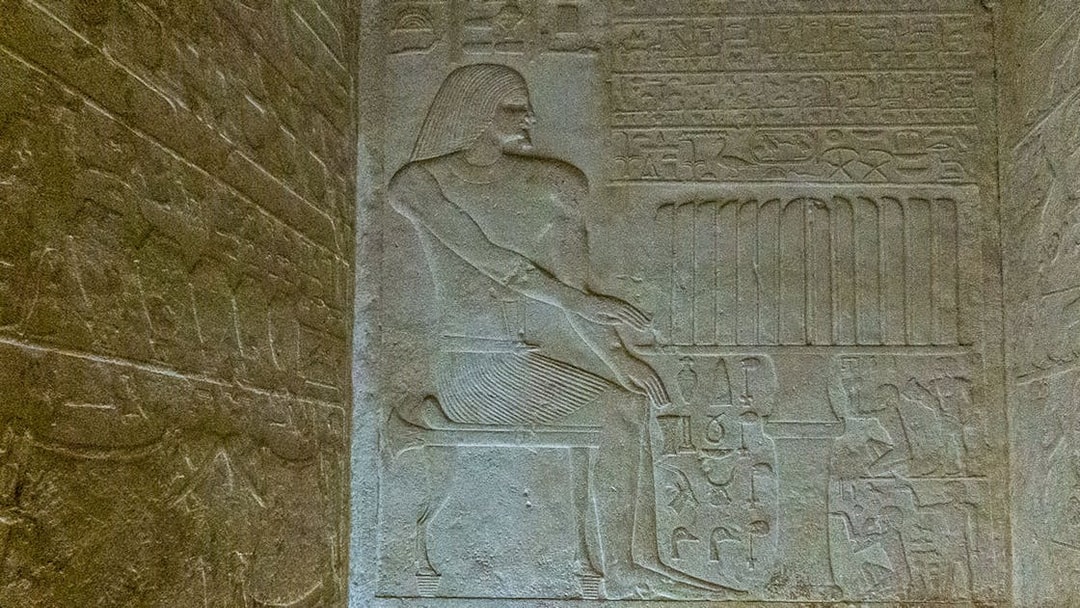 Bas relief depicting a seated figure with hieroglyphs in the Pyramid of Queen Meritetis I, Giza Necropolis, Cairo.
