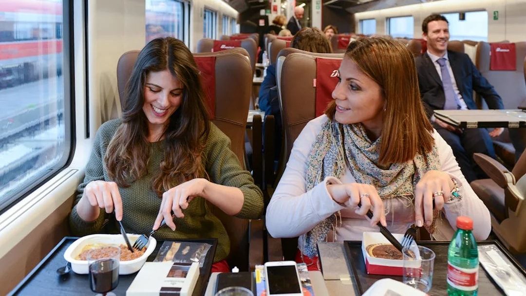 Friends dining on an Interrail train journey.