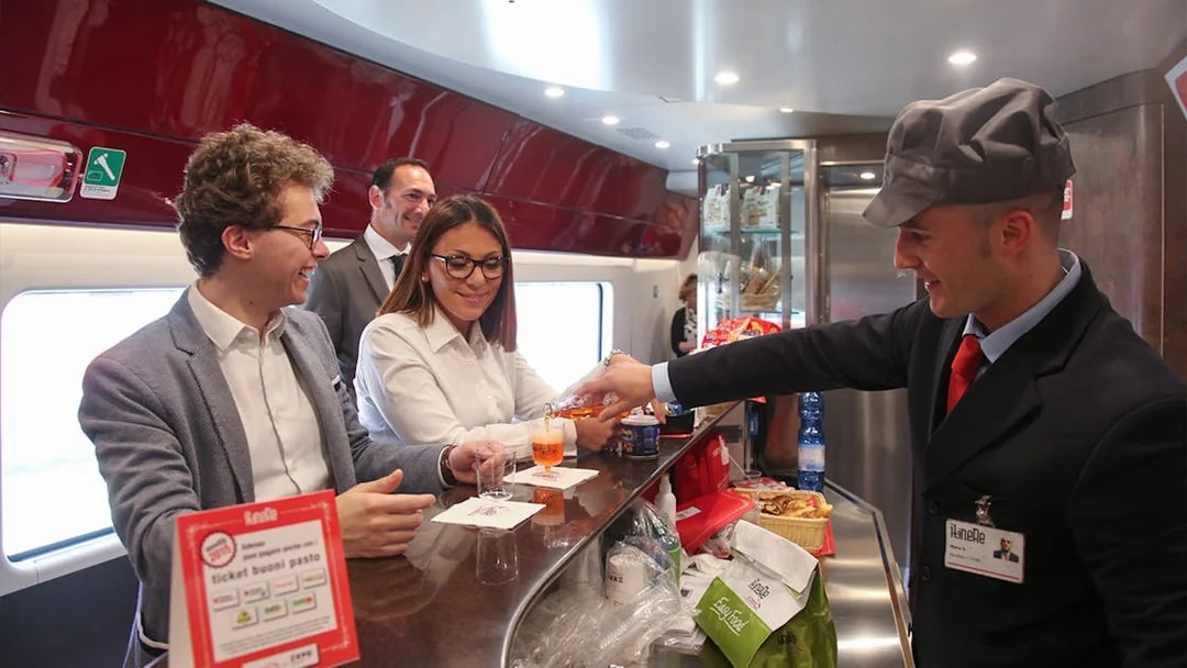 Train passengers enjoying drinks at the bar on an Interrail Global Mobile Pass journey.