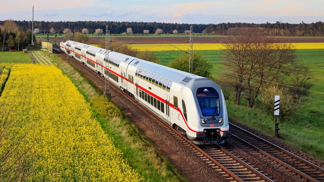 Interrail train traveling through scenic countryside in Germany.