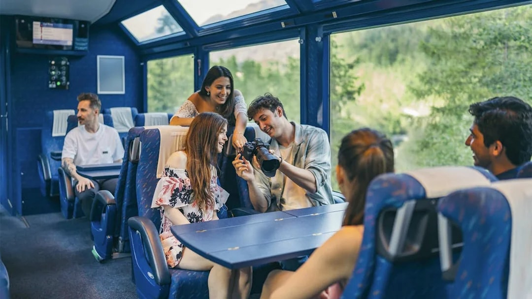 Group enjoying scenic train ride with Interrail Global Mobile Pass Flex.