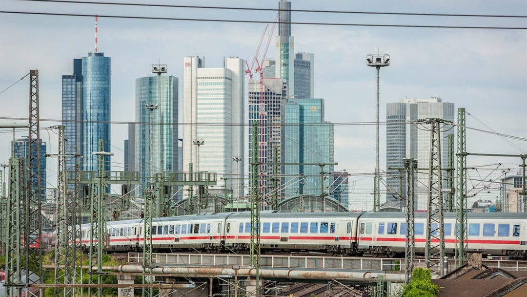 Train passing through Frankfurt with city skyline in the background, Germany.