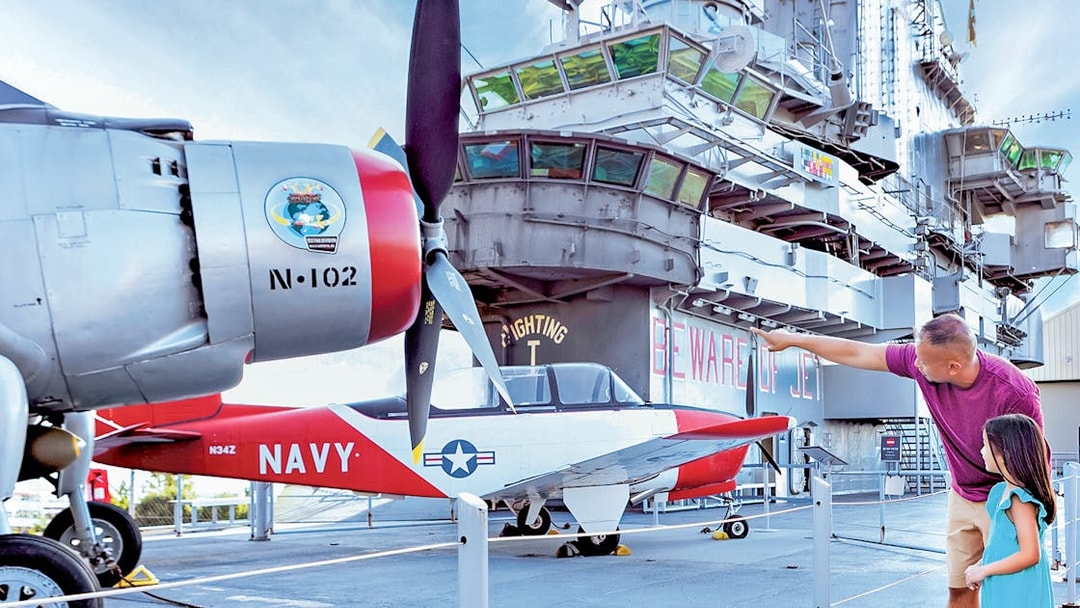 Father and daughter viewing aircraft at Intrepid Museum, New York City.