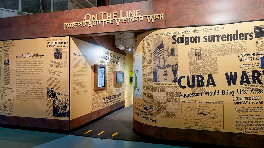 Intrepid Museum's "On the Line" exhibit featuring Vietnam War newspaper headlines.