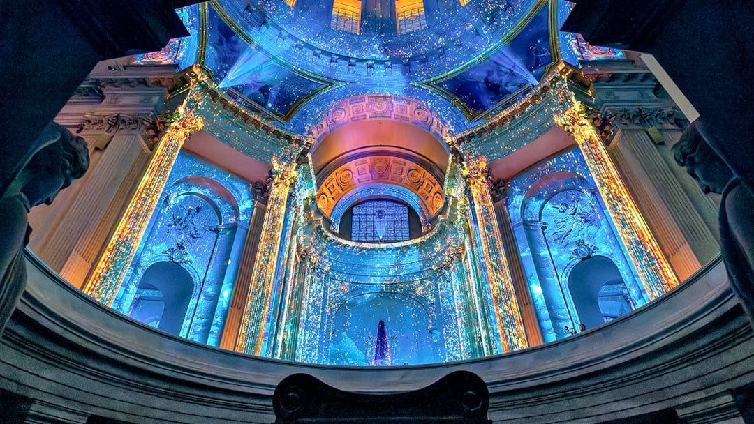 Aura Immersive light show at Invalides, Paris, with vibrant projections on historic architecture.