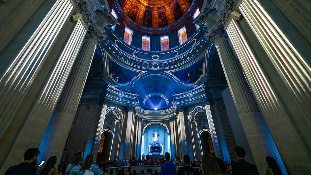 People experiencing Aura Immersive light show at Invalides, Paris.