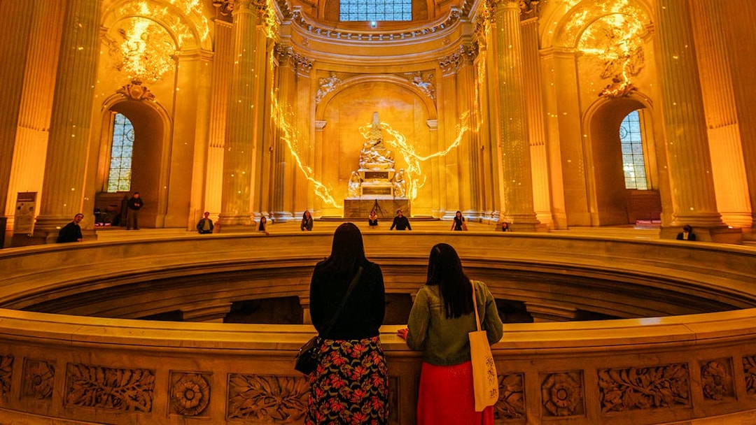 Visitors observing Aura Immersive light display at Invalides, Paris.