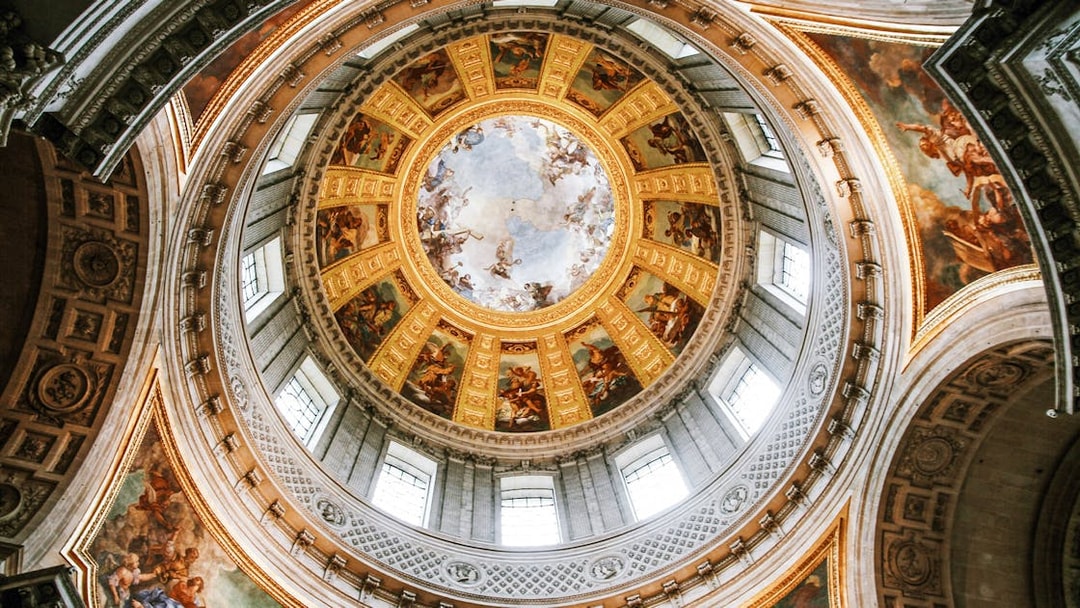Dome of Les Invalides with intricate frescoes and golden details, Paris, France.