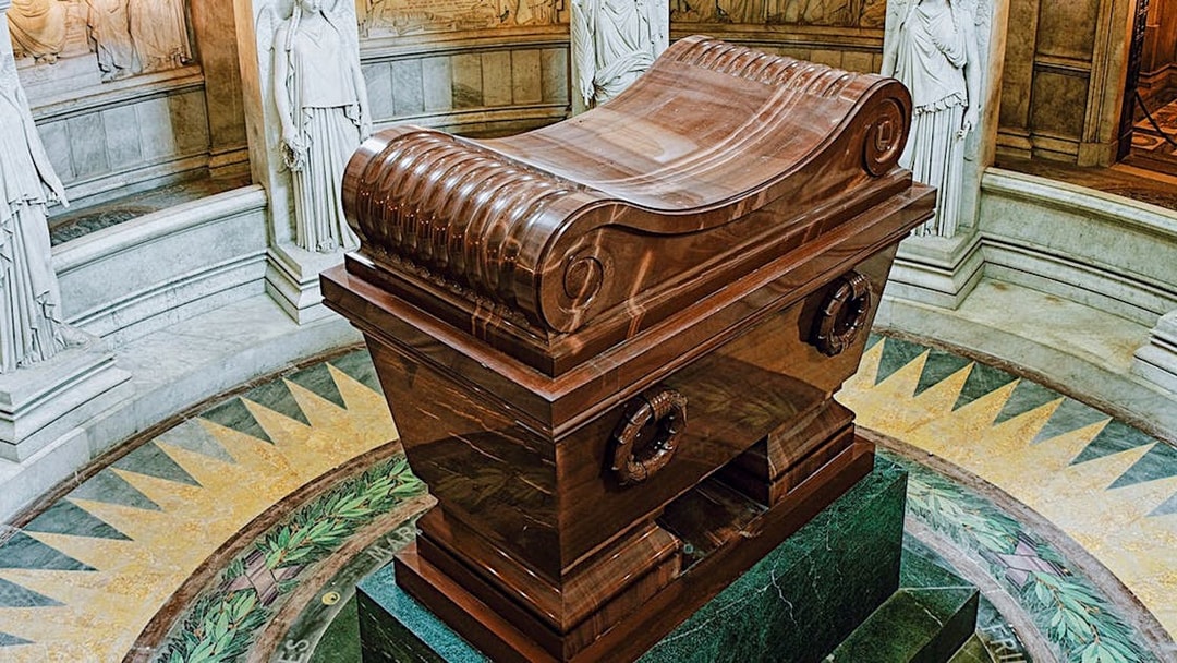 Napoleon Bonaparte’s tomb in Les Invalides, Paris, surrounded by marble statues.