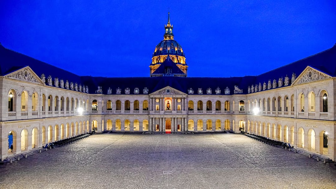 Courtyard of the Army Museum at Les Invalides, Paris, illuminated at night.
