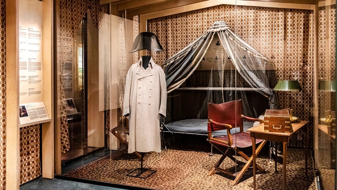 Napoleon's uniform display at Army Museum, Paris, with historical artifacts.