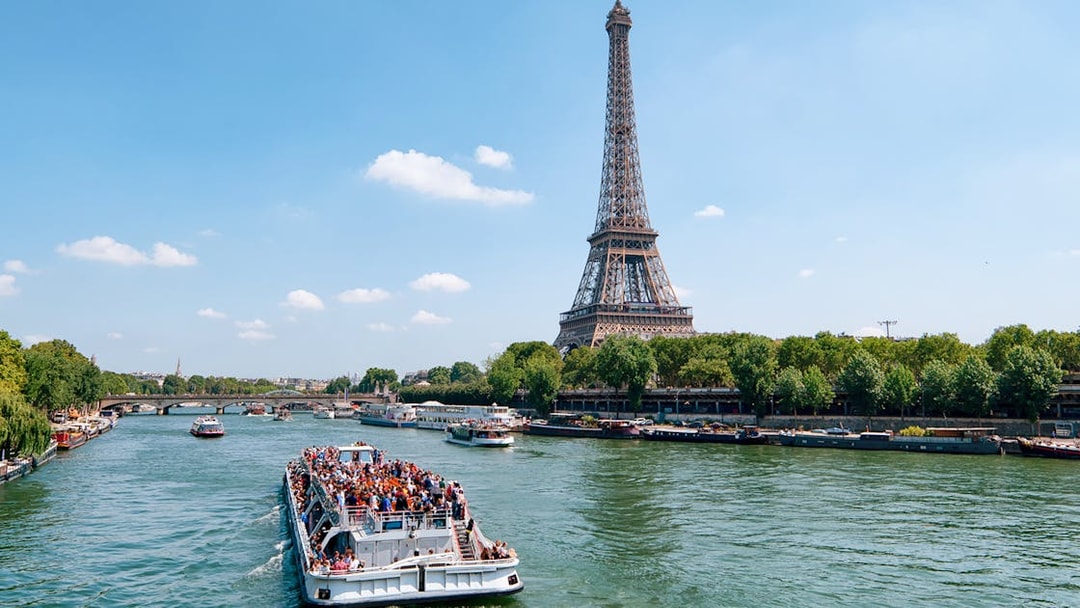 Seine River cruise with view of Eiffel Tower and Parisian architecture.