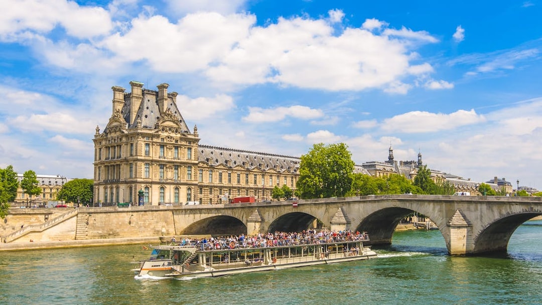 Seine River cruise passing Musée d'Orsay and Pont Royal in Paris.