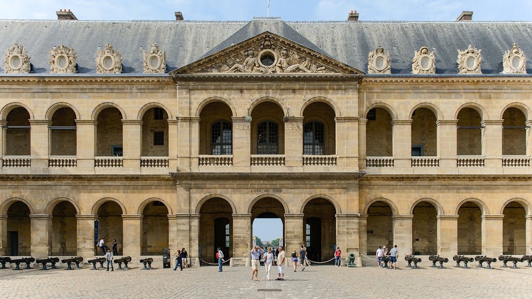 Invalides Courtyard with visitors, view of Napoleon's Tomb and Army Museum, Paris.
