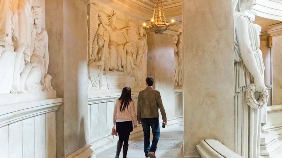 Couple walking through Invalides Napoleon's Tomb in Paris, France.