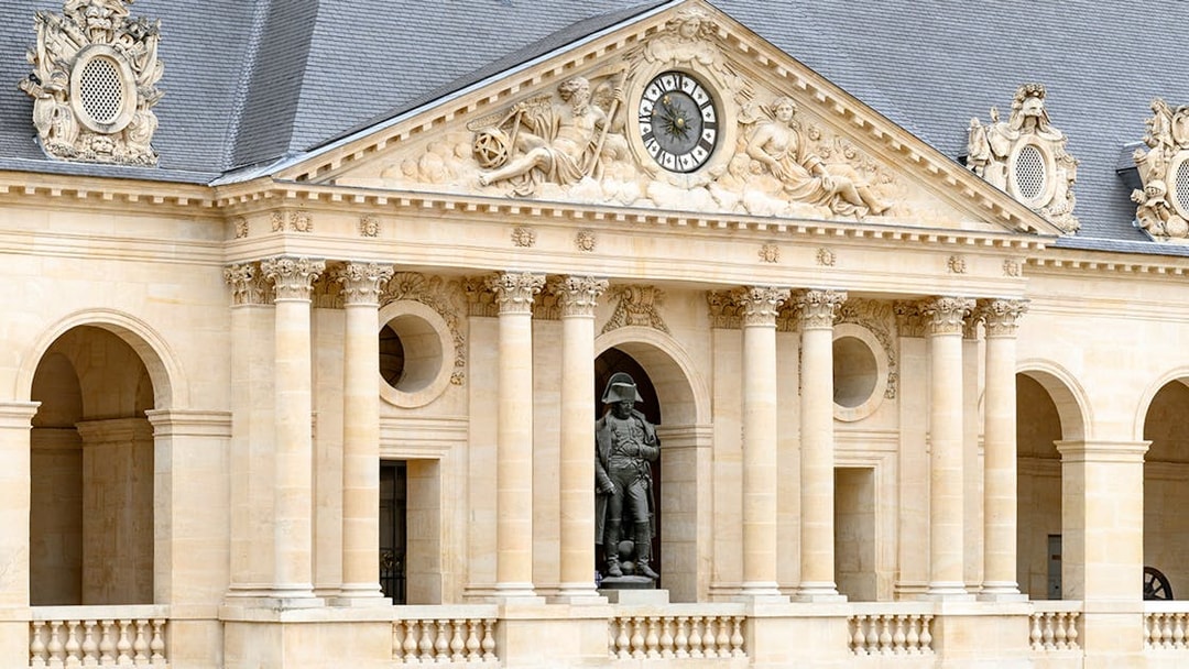 Facade of the Army Museum in Paris with Napoleon statue.
