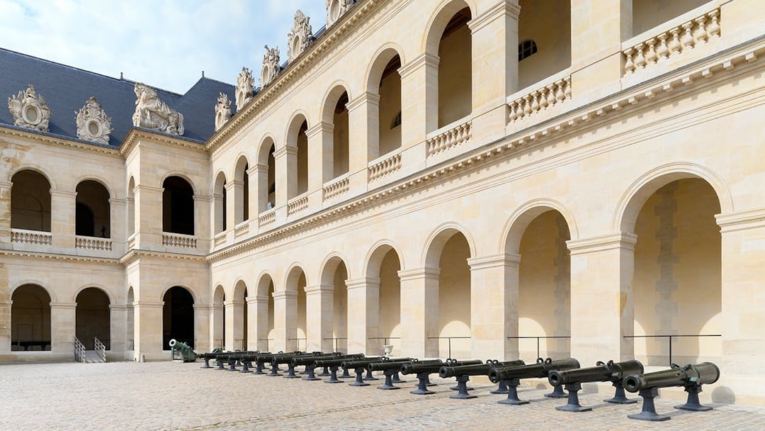 Courtyard of the Army Museum in Paris with historic cannons on display.