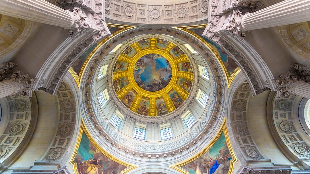 Dome interior of Napoleon's Tomb at the Paris Army Museum, featuring ornate frescoes.