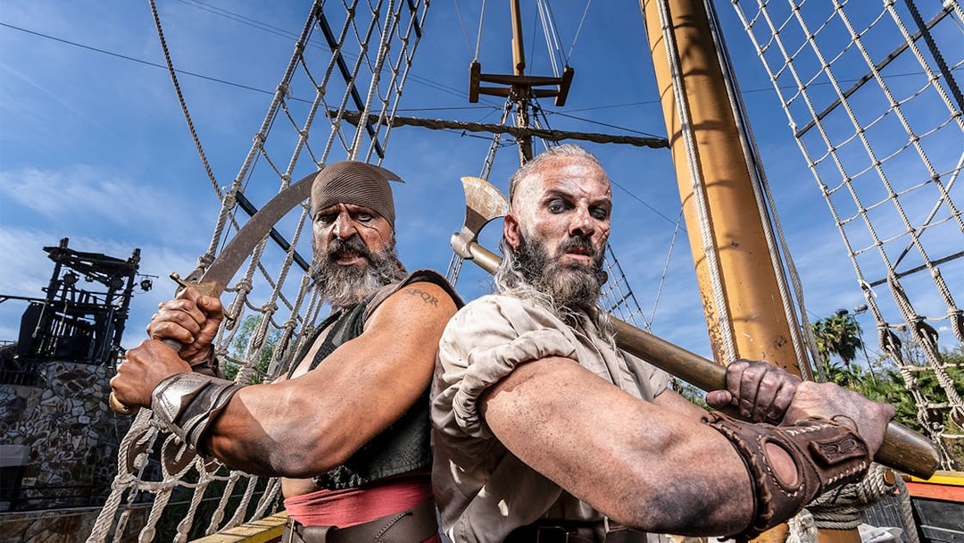 Pirates on a ship at Isla Magica, preparing for a battle with swords and axes.