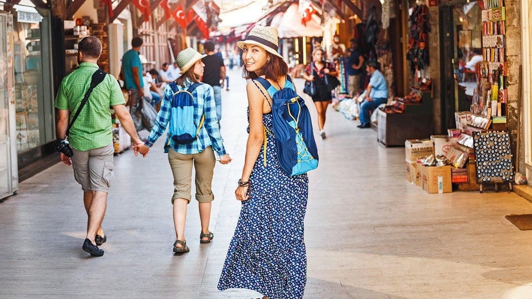 Tourists walking through a bustling Istanbul market en route to Hagia Sophia.