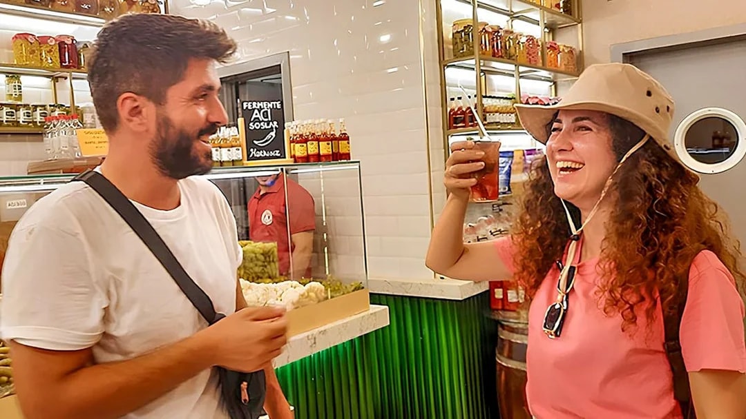 Tourists enjoying a local drink at a shop on Istanbul's Asian side during a walking tour.