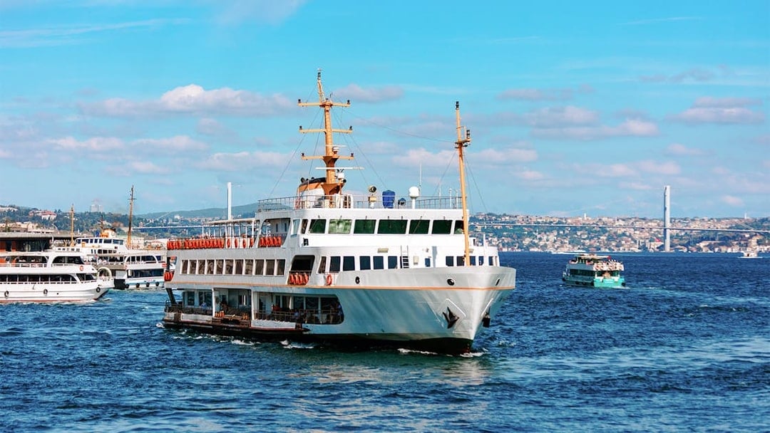 Ferry on the Bosphorus with Istanbul skyline in the background.