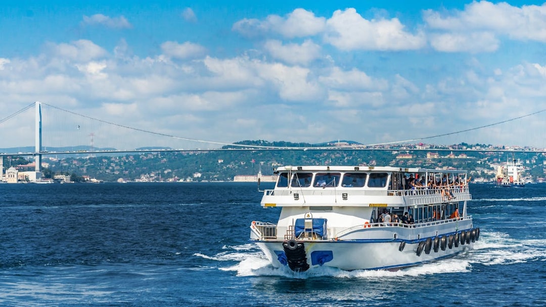 Cruise ship on Bosphorus Strait with bridge in Istanbul, Turkey.