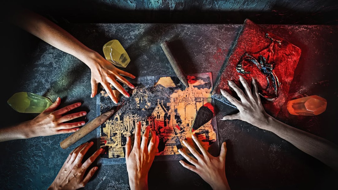 Hands reaching over a map with knives and crystals, part of Saw: The Experience in London.