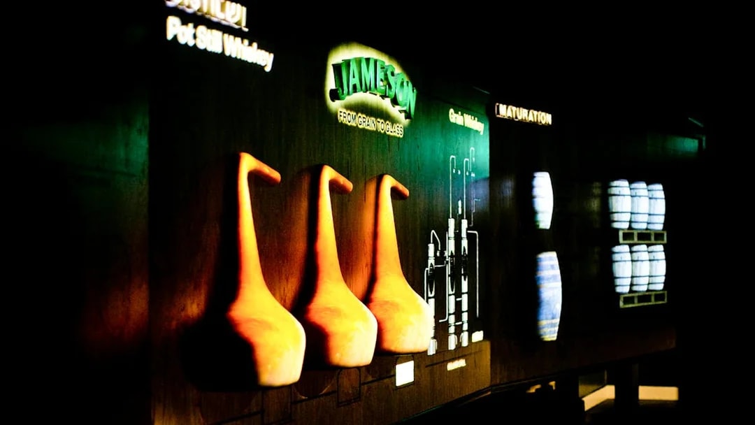 Jameson Distillery display with pot stills and whiskey barrels.