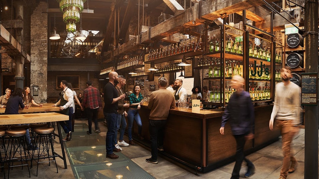 Visitors enjoying tastings at Jameson Whiskey Distillery bar in Dublin.