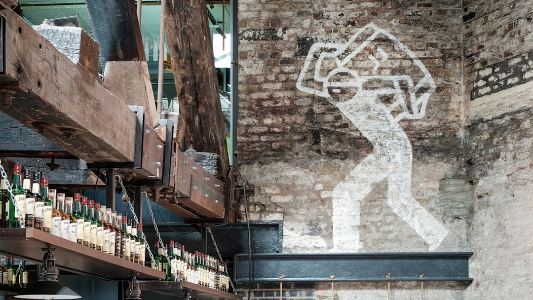 Jameson Distillery interior with whiskey bottles and industrial decor.