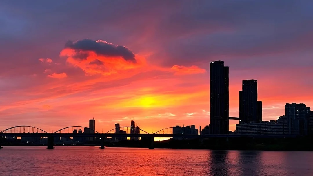 Seoul skyline and bridge at sunset on Hangang Cruise.