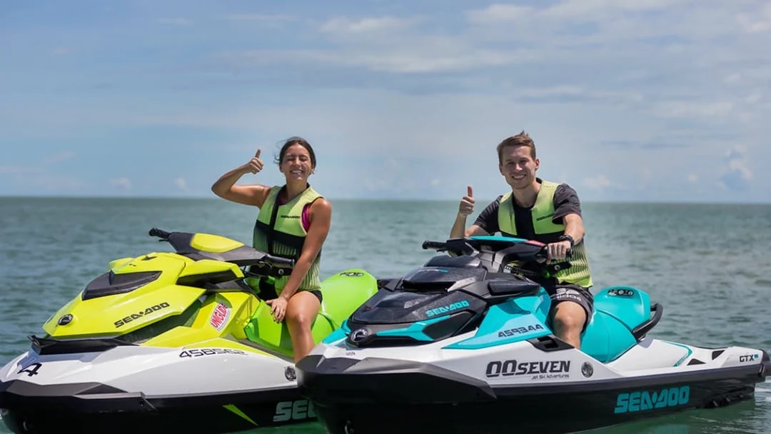 Jet ski riders giving thumbs up on a tour in Darwin waters.