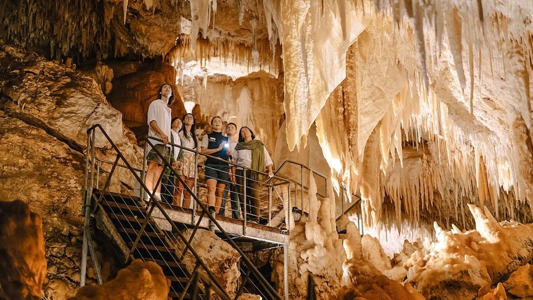 Visitors exploring stalactites in Jewel Cave, Margaret River guided tour.