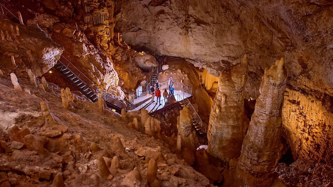Visitors exploring stalactites and stalagmites in Jewel Cave, Margaret River guided tour.