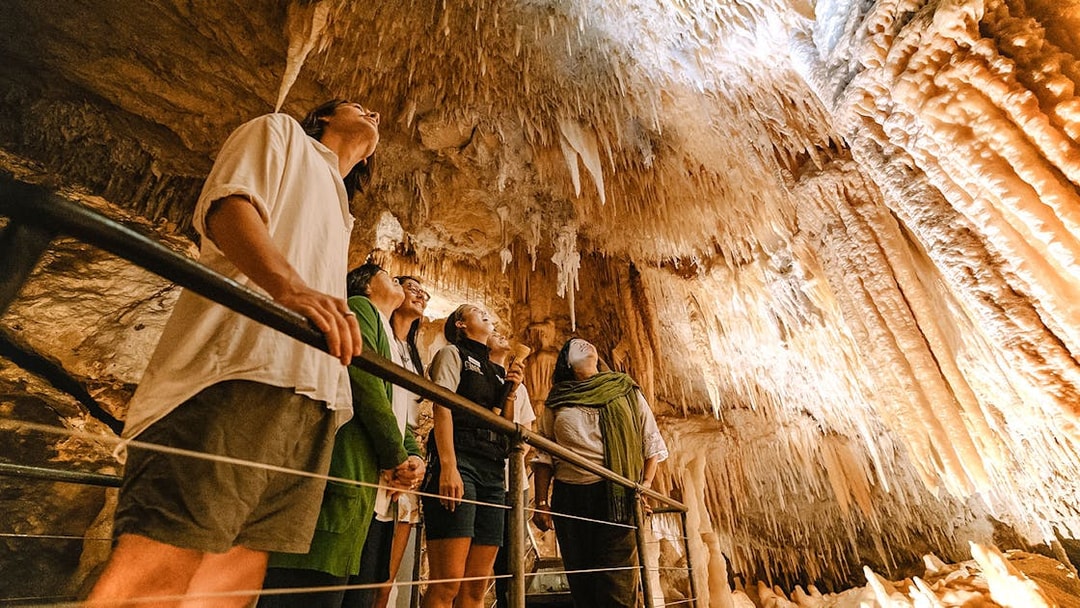 Visitors exploring stalactites in Jewel Cave, Margaret River guided tour.