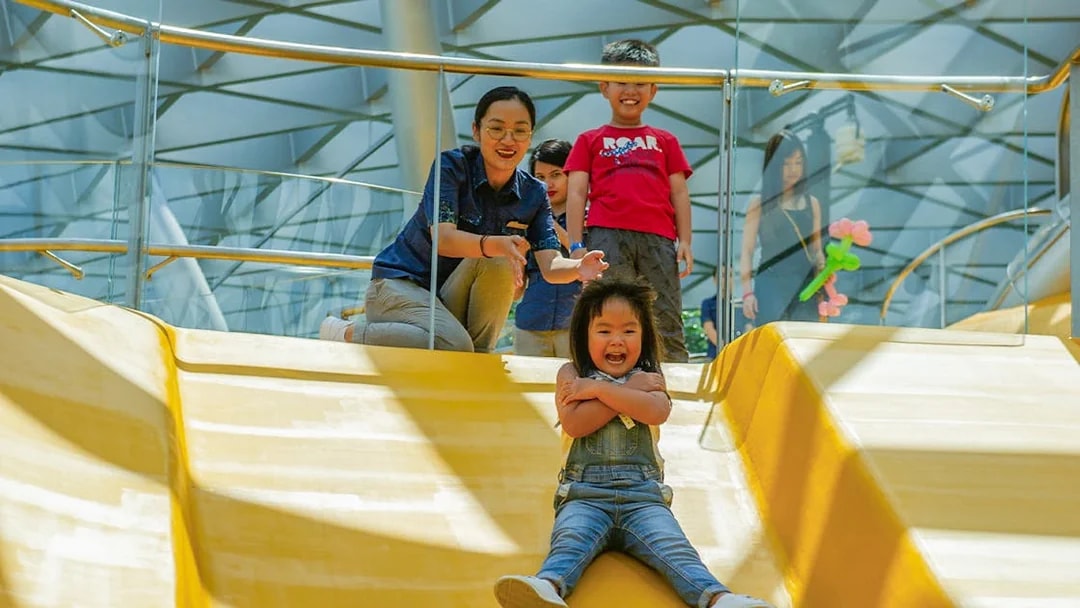 Child sliding down Discovery Slides at Jewel Changi Airport, Singapore.