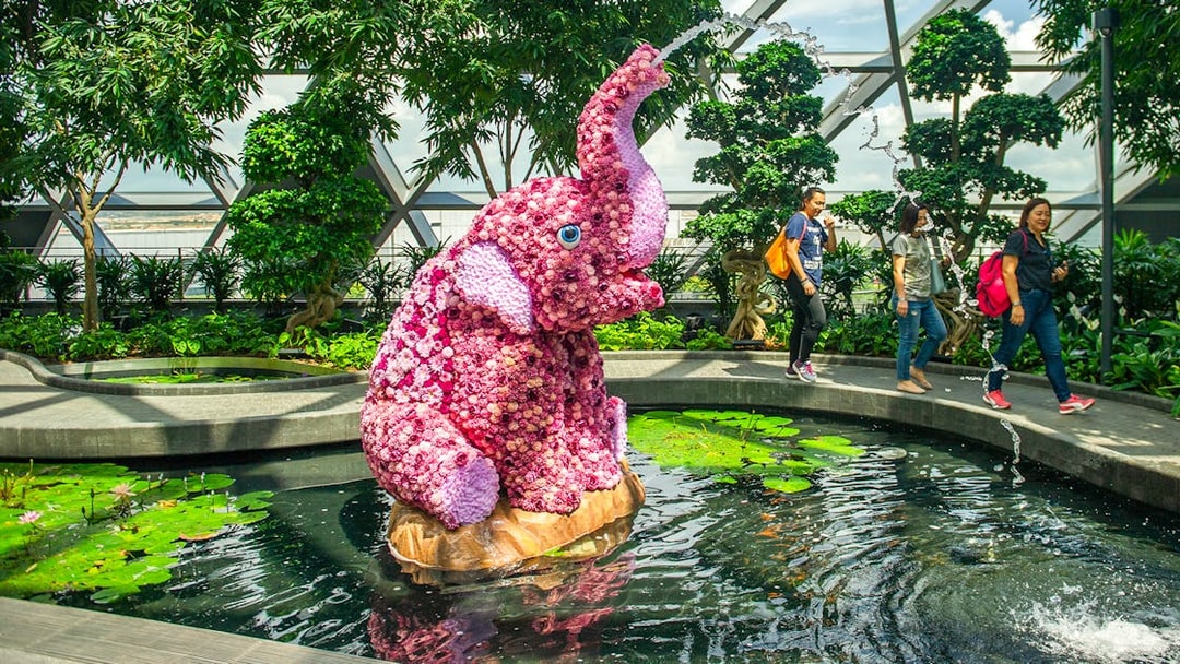 Topiary elephant sculpture in pond at Topiary Walk, Jewel Changi, Singapore.