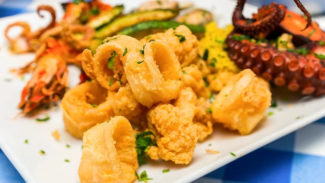 Fried calamari and grilled octopus platter, Jimbaran Bali seafood dinner.