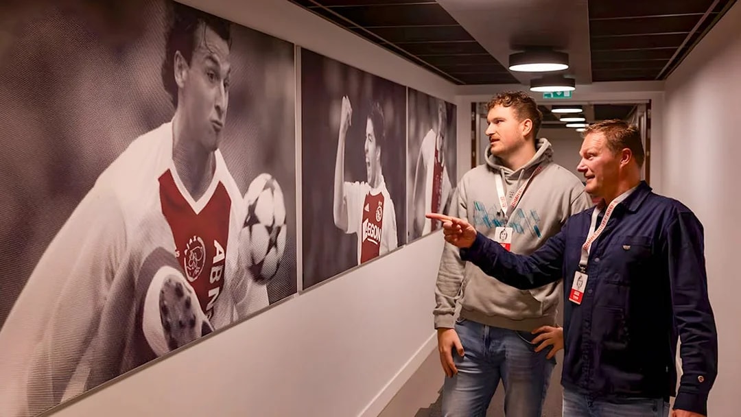 Visitors admire football memorabilia at Johan Cruijff ArenA Classic Tour.