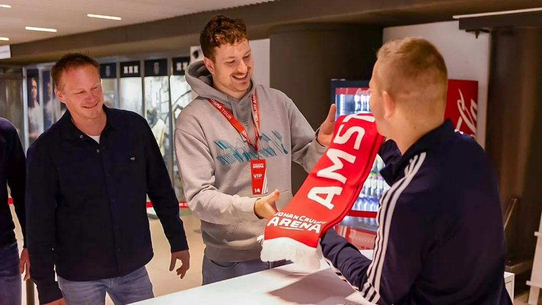 Visitors receiving a scarf during a VIP tour at Johan Cruijff ArenA, Amsterdam.