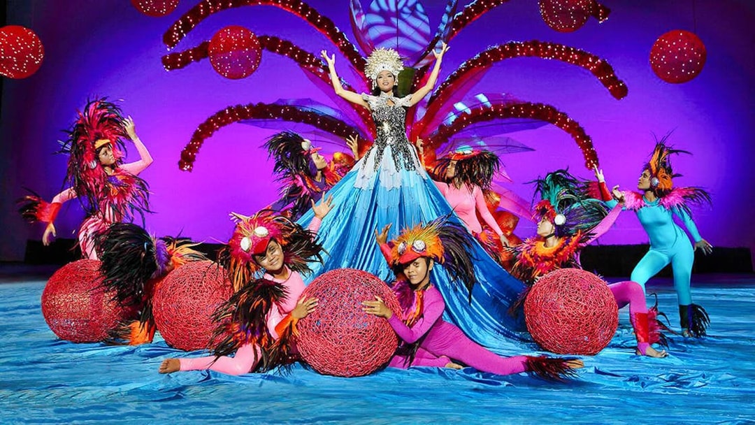 Performers in vibrant costumes at Bali Safari and Marine Park show.