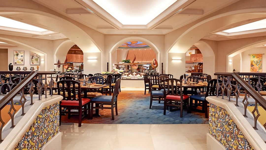 Dining area at Kaleidoscope restaurant, Atlantis Dubai, featuring elegant seating and buffet setup.
