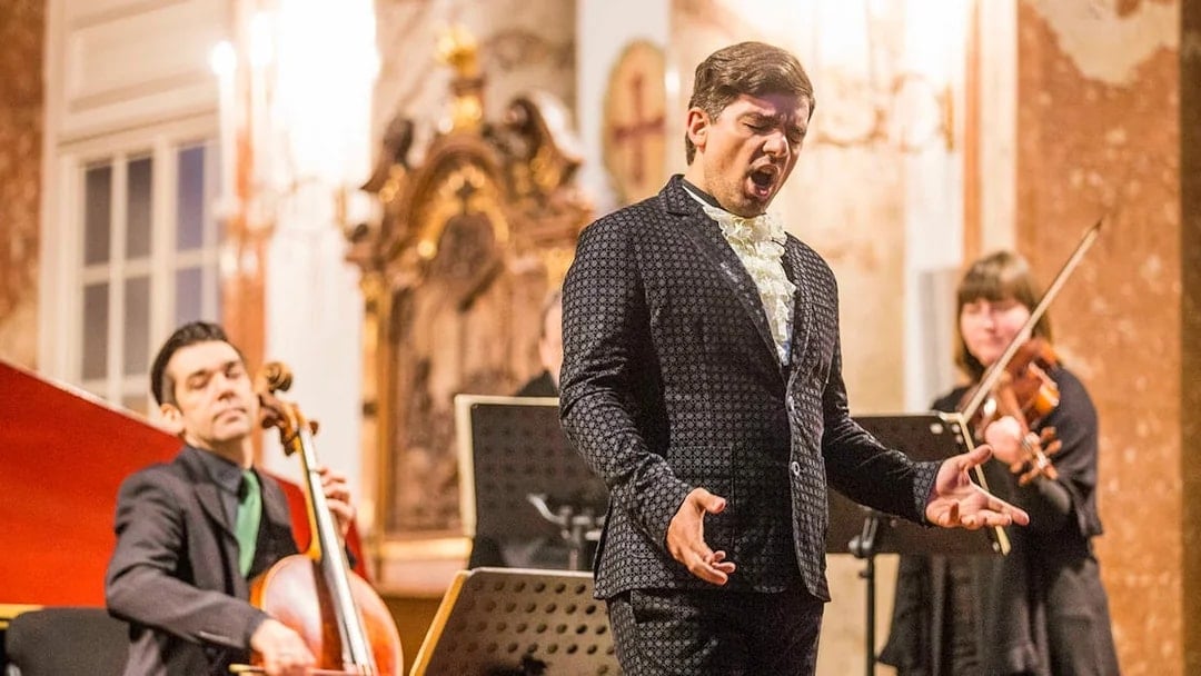 Musicians performing Vivaldi's Four Seasons at Karlskirche, Vienna, with audience in view.