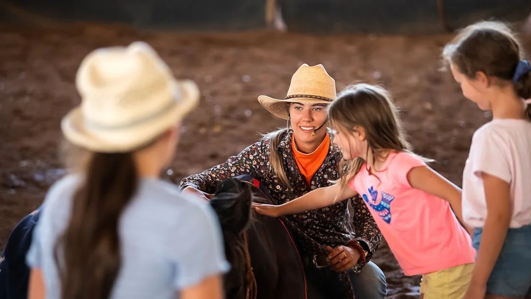 Children interacting with a performer at Katherine Outback Experience show.