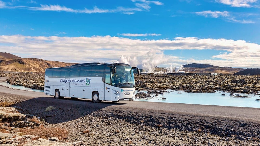 Bus on road near Blue Lagoon geothermal spa in Iceland.