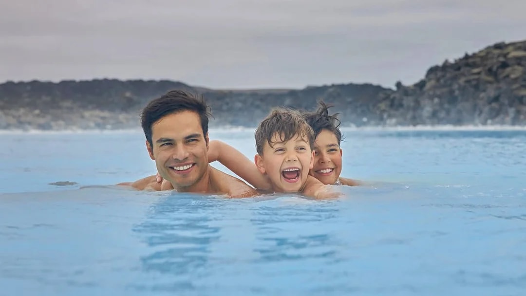Family enjoying the geothermal waters of Blue Lagoon, Iceland.